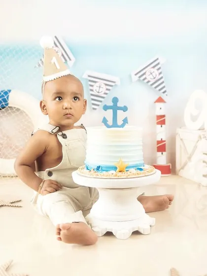 All aboard for a first birthday. This little sailor is ready to celebrate with his nautical-themed cake smash setup.