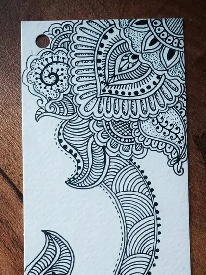 The top portion of my hand-drawn paisley bookmark. Creating these detailed zentangle-inspired designs is a passion of mine and a core technique I teach for stress relief.