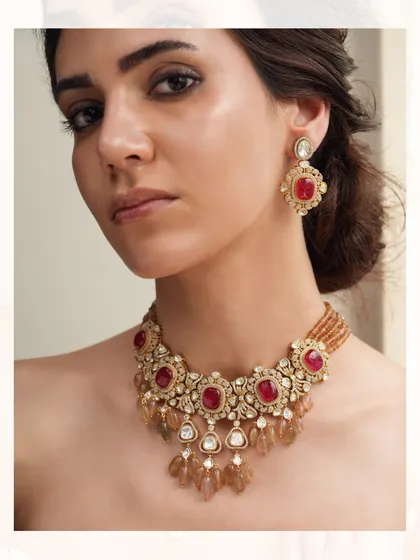 A rich and royal necklace set, featuring deep red stones and polki diamonds with cascading drops, perfect for a bride.