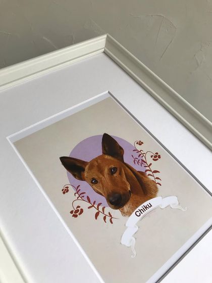 A close-up shot of the framed Chiku portrait, focusing on the artwork itself. The frame protects the print while enhancing its visual appeal.