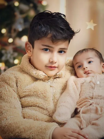 A first Christmas together is a memory to be treasured. I love capturing the quiet bond between siblings, especially during the magical holiday season.