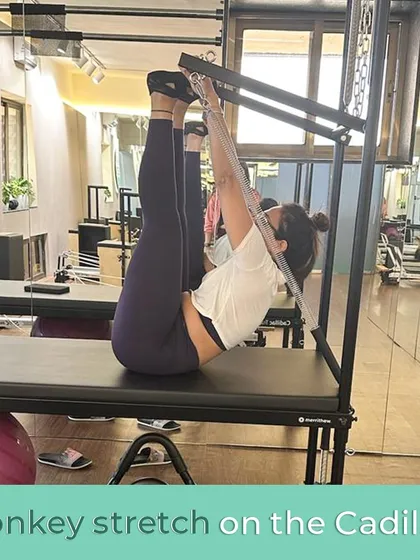 The monkey stretch on the Cadillac feels as good as it looks, providing a deep and satisfying hamstring and spinal stretch.