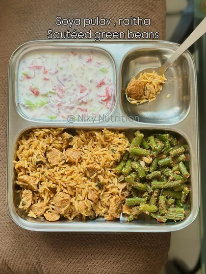 A protein-packed vegetarian meal of soya pulav, raita, and sautéed green beans. Soya chunks are an excellent source of plant-based protein.