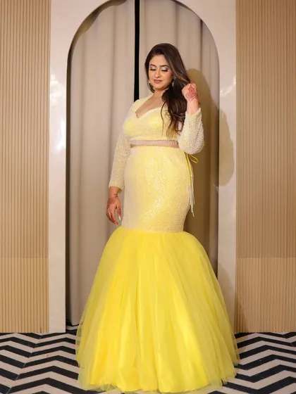 Another look at the sunshine yellow plus-size fish-cut lehenga. The sequined top and the dramatic tulle bottom create a fun and glamorous silhouette.