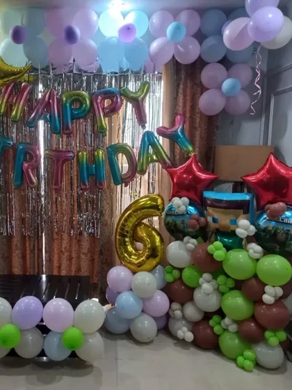 A birthday setup for twins with two different color schemes on each side of the backdrop.