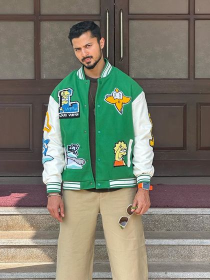 A direct, full-frontal shot of the patched varsity jacket, perfect for a product-focused image.