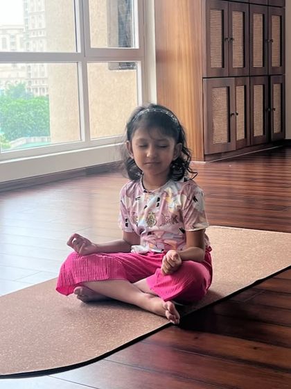 A young student sits peacefully in Padmasana (Lotus Pose), showing a natural connection to mindfulness.