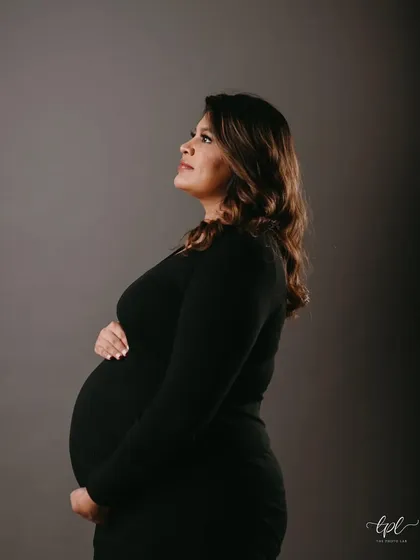 A classic studio portrait for a maternity shoot. The makeup is elegant and timeless, with soft definition on the eyes and a flawless base to create a polished and sophisticated look.