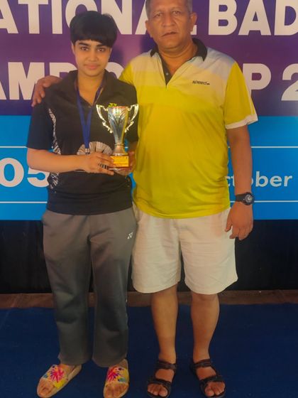 **Runner-Up at the Nationals.** Ridhima proudly poses with her trophy and mentor after securing the Runner-Up position in Mixed Doubles at the National Championship.