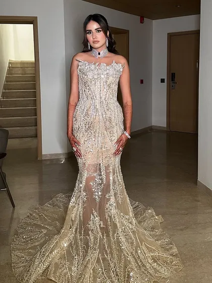 The full mermaid gown is a statement. The makeup is kept elegant and classic to balance the overall look.