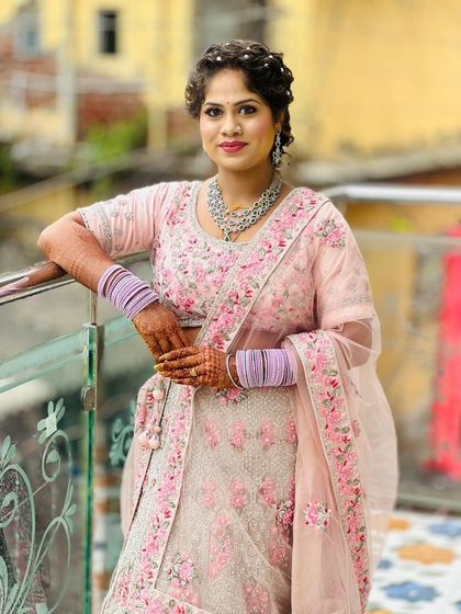 A beautiful client looking picture-perfect in a pastel pink floral lehenga. The intricate embroidery and soft colour are ideal for a spring or summer wedding.