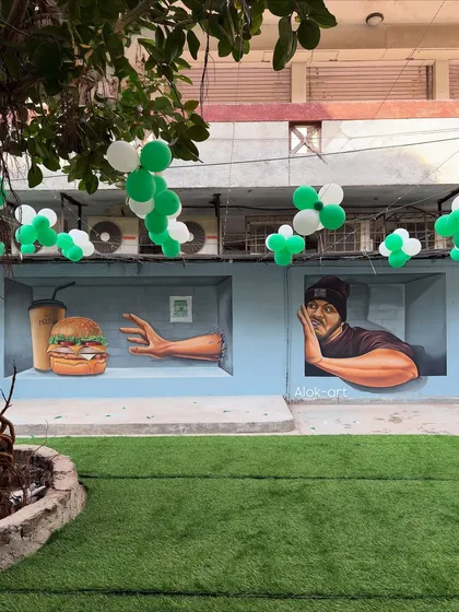 The cafe mural decorated with balloons for an event. It shows how the artwork becomes a versatile backdrop for the daily life and special occasions of the business.