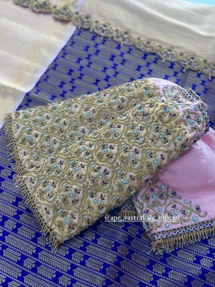 The sleeves of the lavender blouse, with dense floral embroidery.