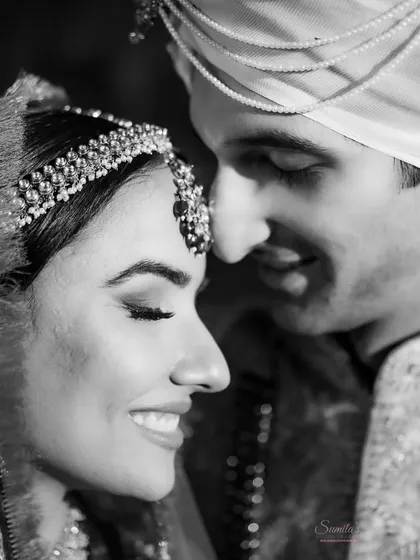 An intimate close-up of the bride and groom. This timeless black and white portrait is all about their gentle smiles and closeness.