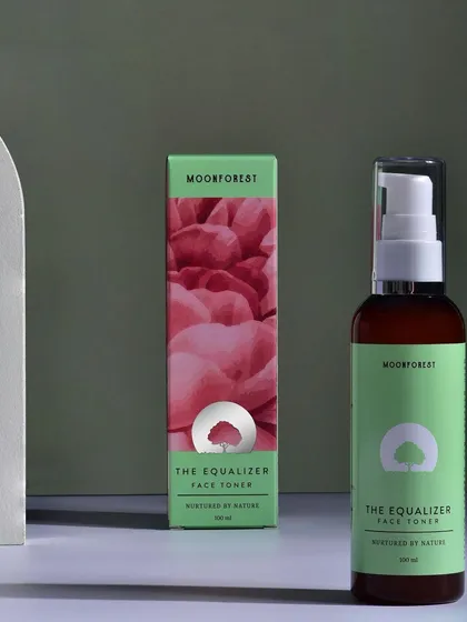 A clean, studio shot of Moon Forest's face toner and its packaging. The soft lighting and simple background keep the focus on the product's elegant design.
