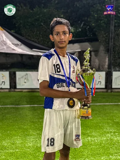 One of our promising U-13 players proudly holding the trophy.