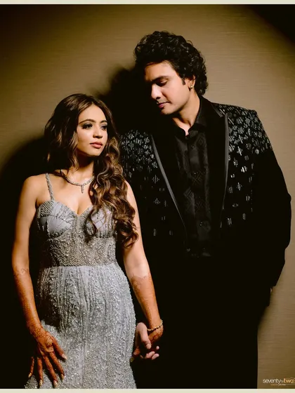 A stylish portrait of the couple at their cocktail party, holding hands and looking effortlessly elegant.