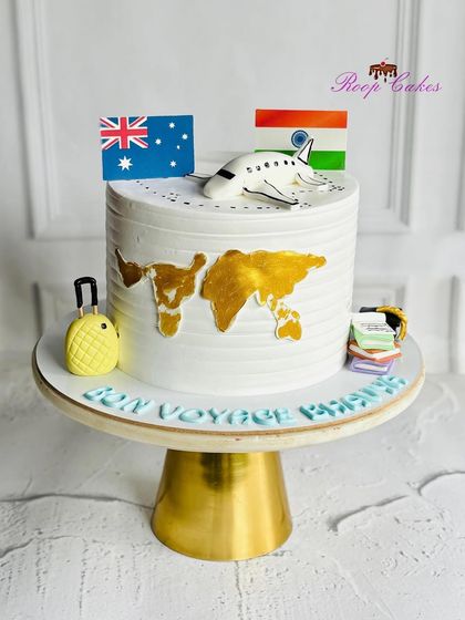 Bon Voyage. This travel-themed cake is perfect for someone embarking on a new journey abroad, featuring a world map, flags, a suitcase, and an airplane.