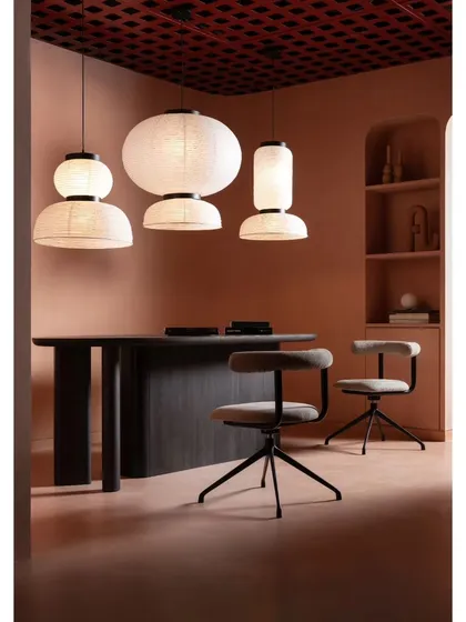 A retail space should also be a functional workspace for the brand. In this section of the showroom, we designed a client consultation area with a custom dark wood table and sculptural paper lanterns, blending business with beauty.