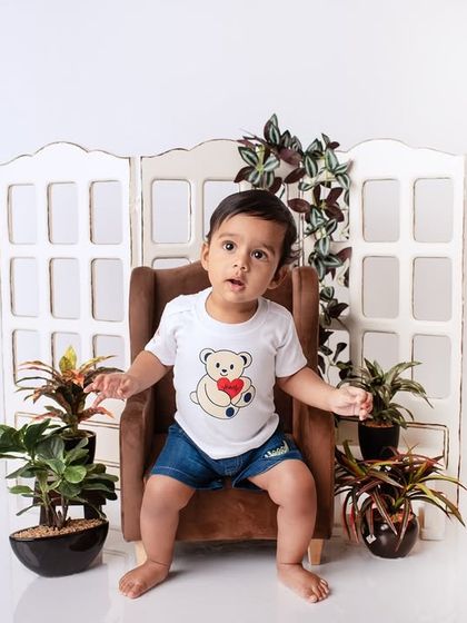 A simple and clean studio portrait of a baby boy. The white background and minimal props ensure that his sweet face is the star of the show.