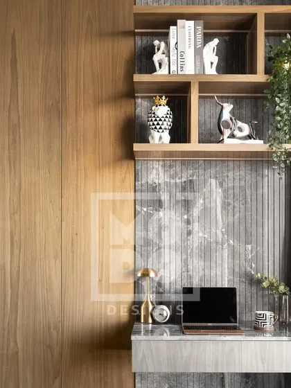 This bedroom in our Dadar project features an integrated study nook. The combination of warm wood paneling and a grey marble desk creates a workspace that is both stylish and functional.