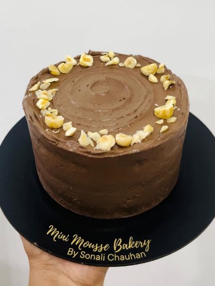 A simple yet elegant hazelnut chocolate cake. The rich chocolate frosting is complemented by the crunch of toasted hazelnuts on top.