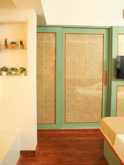 A niche with glass shelves provides a perfect spot for small plants and decor, adding a personal touch to the room.