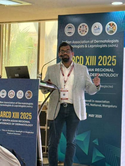 A dynamic shot of me on stage at the South Asian Regional Conference of Dermatology (SARCD) XIII 2025.