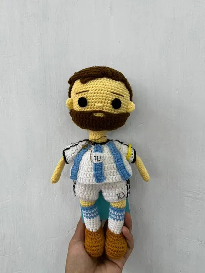A clear, front-facing shot of the handmade Messi doll, capturing the details of his number 10 jersey.