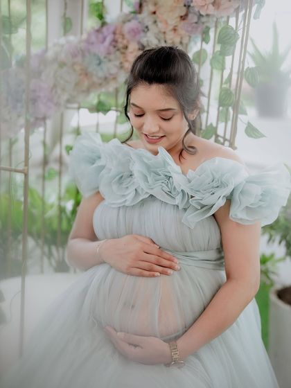 This close-up highlights the special center slit on our Isabella gown, designed to beautifully and tastefully showcase your baby bump for those iconic maternity shots.