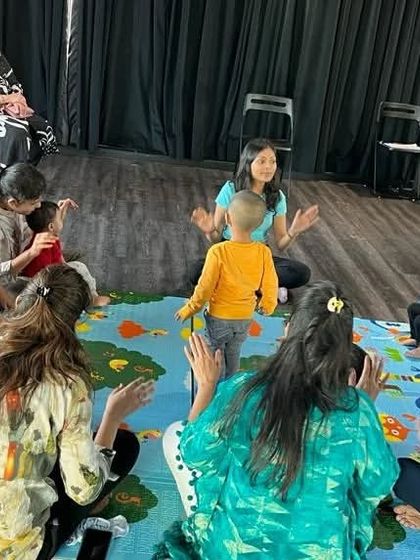 A child in the center of the circle feels the rhythm and moves along. My classes are a safe space for little ones to express themselves without any pressure to perform.