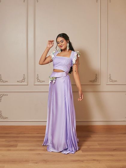 A full-length shot of the 'Genevive' outfit. The floral and shell details on the sleeves and belt add a whimsical, garden-esque touch.