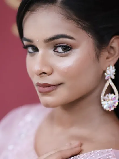 A close-up portrait that captures the glossy, well-defined eye makeup and the perfectly shaped brows.