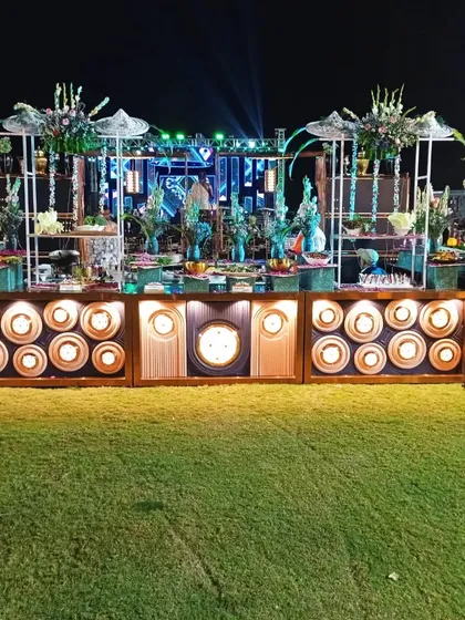 This is an example of my large-scale outdoor catering for a wedding, featuring an elaborate, multi-tiered salad bar that serves as a stunning centerpiece on the lawn.