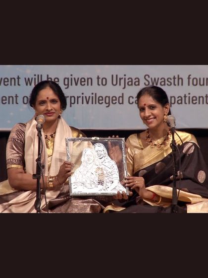 The renowned Carnatic duo Ranjani and Gayatri holding the portrait I made for them during a performance. I'm so grateful I could create something for artists I admire so much.