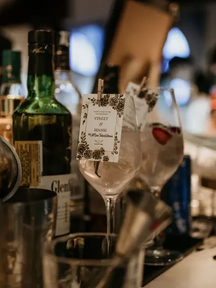 Even the garnishes get a personal touch. This gin cocktail is served with a custom tag featuring the couple's names, making each drink feel special.