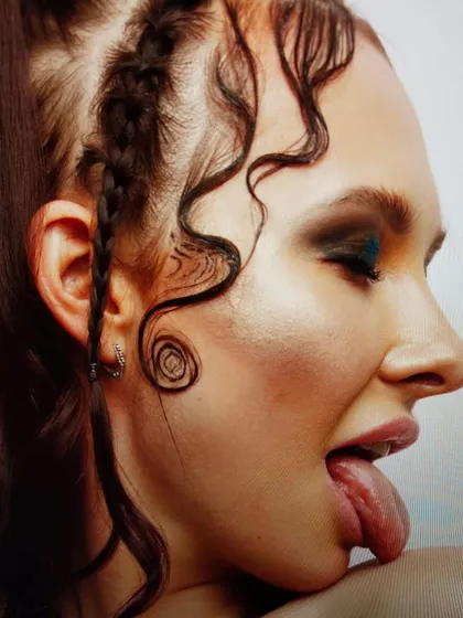 An edgy look combining intricate hair styling with a dark, smoky eye. The makeup is designed to complement the unconventional hairstyle, creating a cohesive and provocative editorial image.