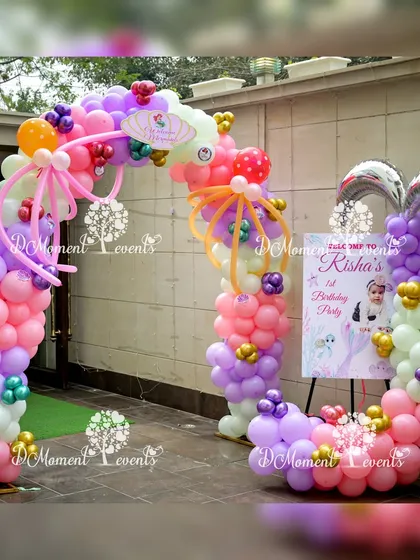 A charming entrance for a first birthday mermaid party, with a personalized welcome sign and a balloon arch featuring a mermaid tail.