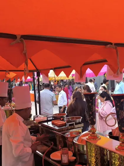 Our chefs in action at a live cooking station during an outdoor event. We bring all the necessary equipment to prepare fresh and hot food on-site, providing a truly gourmet experience for your guests.