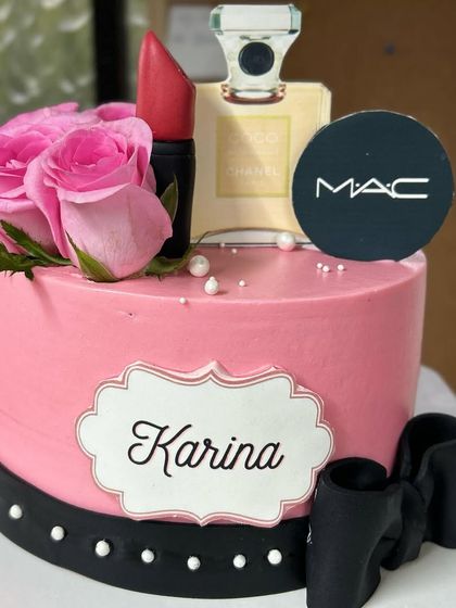 The perfect cake for a makeup lover! This design is themed around MAC and Chanel, featuring an edible lipstick, perfume bottle, and compact.