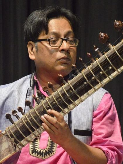 A close-up of Pandit Partha Pratim Roy, deeply engrossed in playing the sitar. His mastery is a benchmark for our students of Indian classical music.