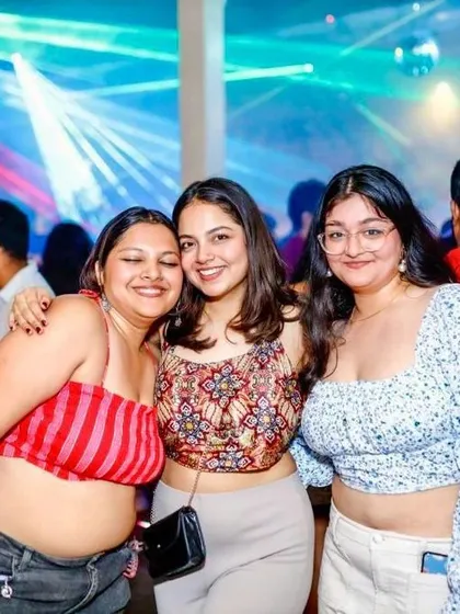 The same group of happy friends, captured again enjoying the night. It's great to see familiar faces returning for more fun.