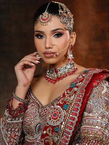 Another angle of this stunning regal look. The contour is sharp, and the skin is glowing, creating a very high-fashion bridal statement.