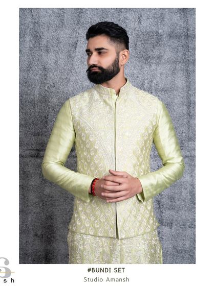 The mint green bundi jacket, a showcase of traditional craftsmanship. The hand-embroidered silk thread designs add a layer of elegance to this refreshing summer piece.