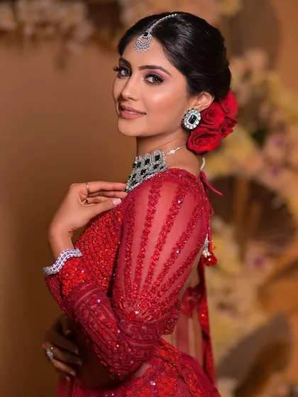 A final portrait of this beautiful bride in red. Her makeup is flawless, and the red roses in her hair add that perfect finishing touch of romance.