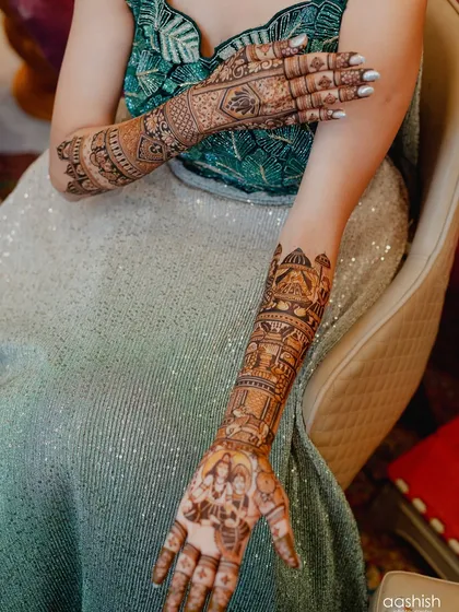 A full view of the bride's arms, showing the complete storytelling design from the palms to the elbows.