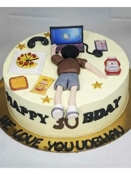 A fun cake for a workaholic husband's 30th birthday. This fresh pineapple cake is decorated with all his essentials: a laptop, pizza, and snacks.