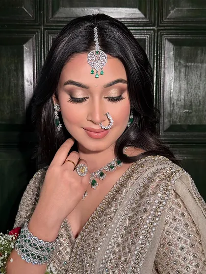 A beautiful soft glam look perfect for a wedding guest. The focus is on flawless skin and softly defined eyes, complemented by stunning emerald and diamond jewellery.