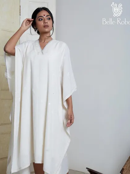 A minimalist and elegant makeup look for the brand Belle Robe. Featuring a simple bindi and natural-looking skin, this look is designed to complement the serene and classic aesthetic of the white kaftan.