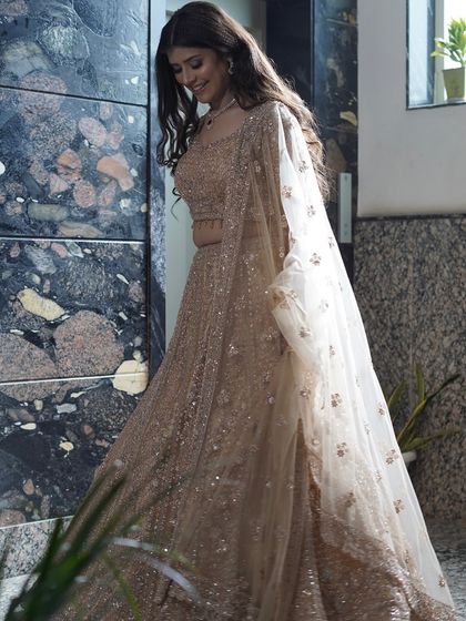A candid, walking shot of Harshita in her beautiful engagement lehenga. The movement shows how the makeup and outfit come together perfectly.